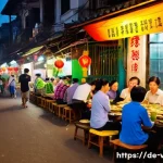 베트남 하노이 야경 명소 - **Prompt:** A bustling Hanoi street scene at night. Focus on a family of tourists sitting on small p...